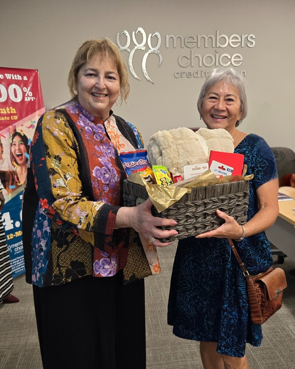 Family basket winner posing with MCCU board member